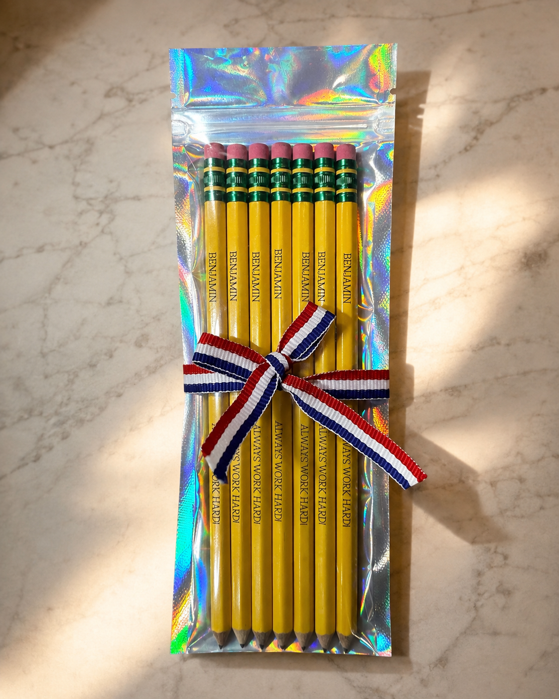 Custom engraved pencils with personalized name and slogan, bundled with a patriotic ribbon