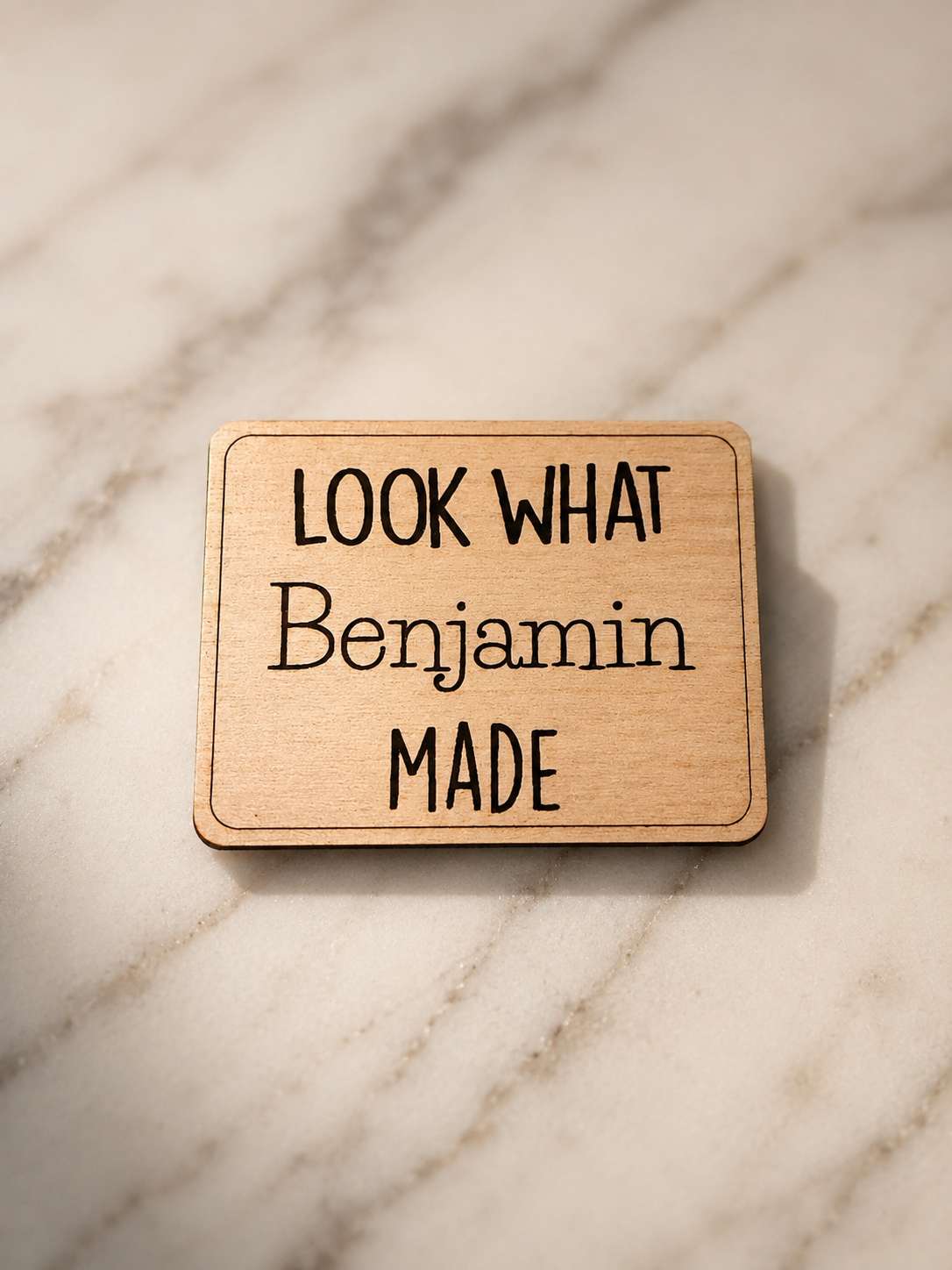 Custom laser-engraved wood magnet personalized with a child's name