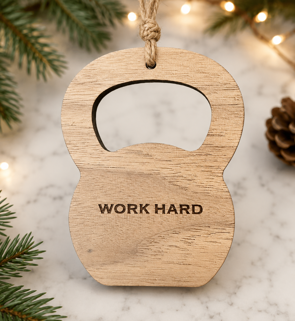 Laser-engraved wooden kettlebell ornament with jute twine hanger, engraved with WORK HARD