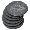 Stack of six laser-engraved slate coasters with custom brewery logo